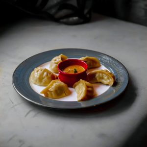 Steamed momos served with curry dipping sauce at Panas Indian Dining in Twickenham