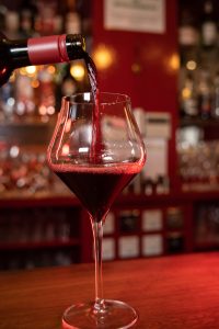 Red wine being poured into a glass at Panas Indian Dining in Twickenham