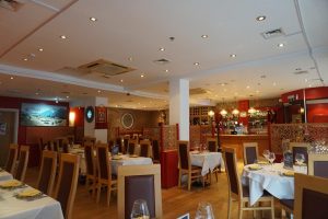 Beautifully arranged interior dining area of Panas Indian Dining with tables and chairs