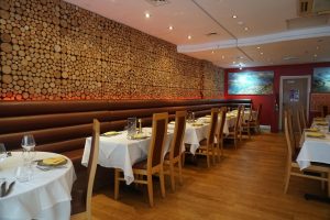 Interior dining area of Panas Indian Dining with tables and chairs arranged